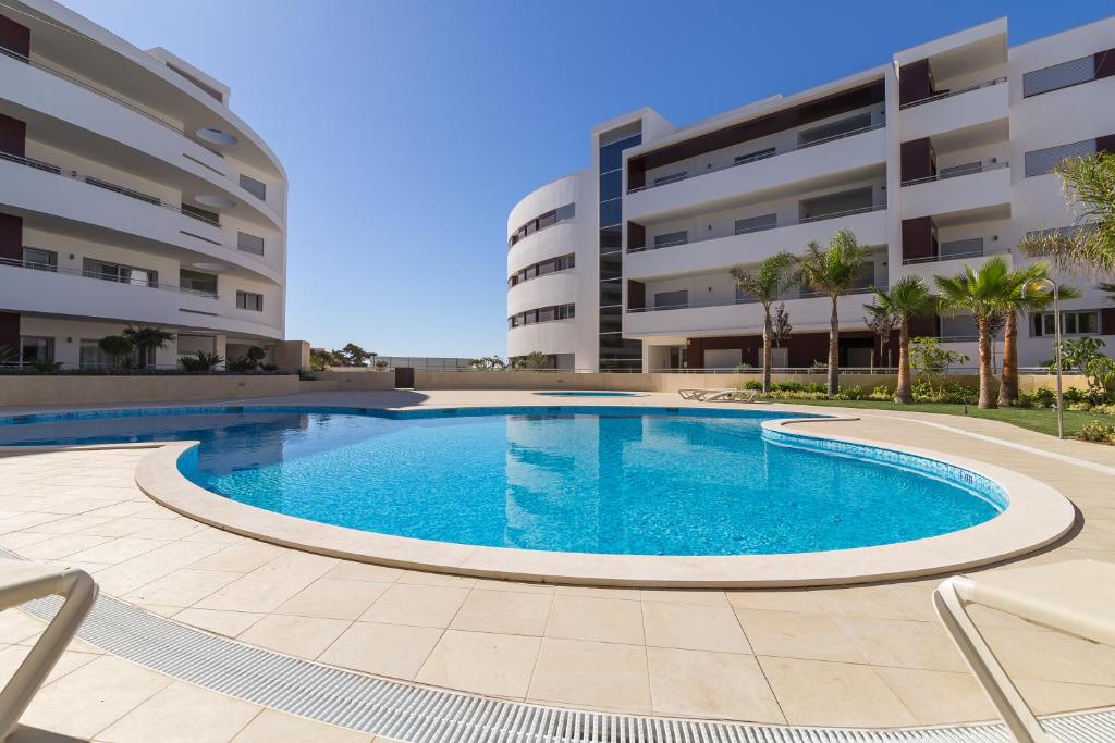 a swimming pool in front of a building at Beach Condominium in Lagos