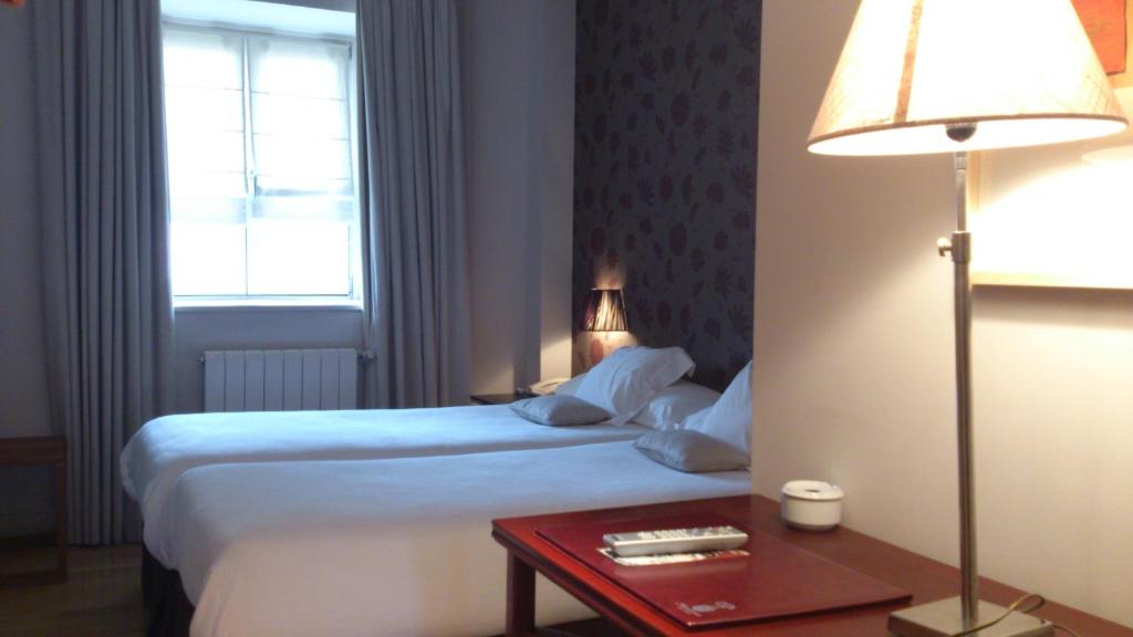 Postel nebo postele na pokoji v ubytování Hotel Palacio Muñatones