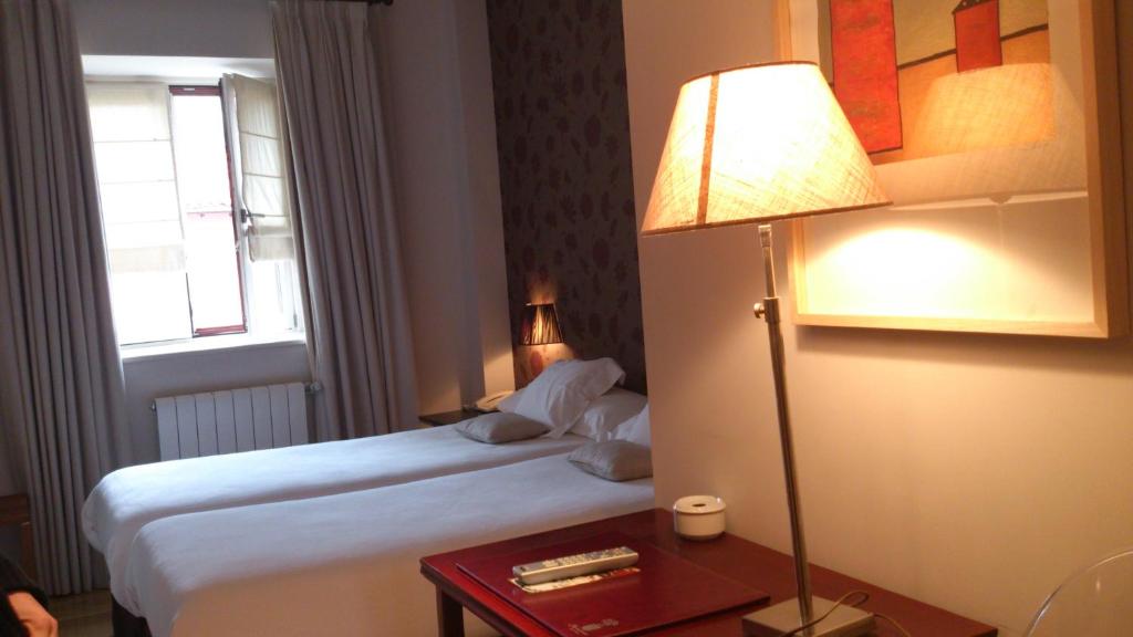 Postel nebo postele na pokoji v ubytování Hotel Palacio Muñatones