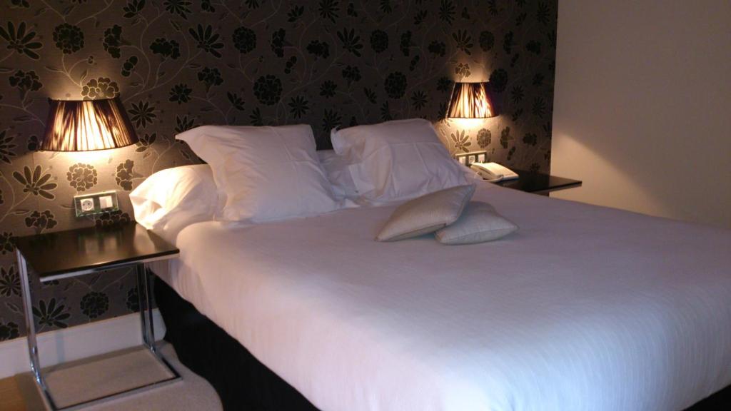 Postel nebo postele na pokoji v ubytování Hotel Palacio Muñatones