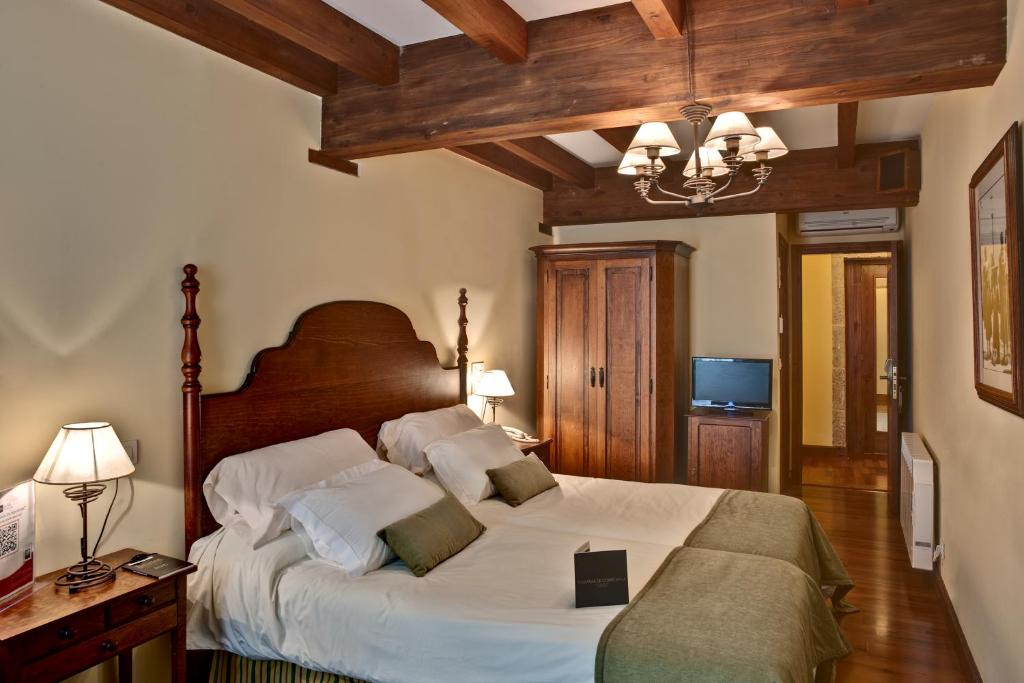 A bed or beds in a room at Airas Nunes by Pousadas de Compostela