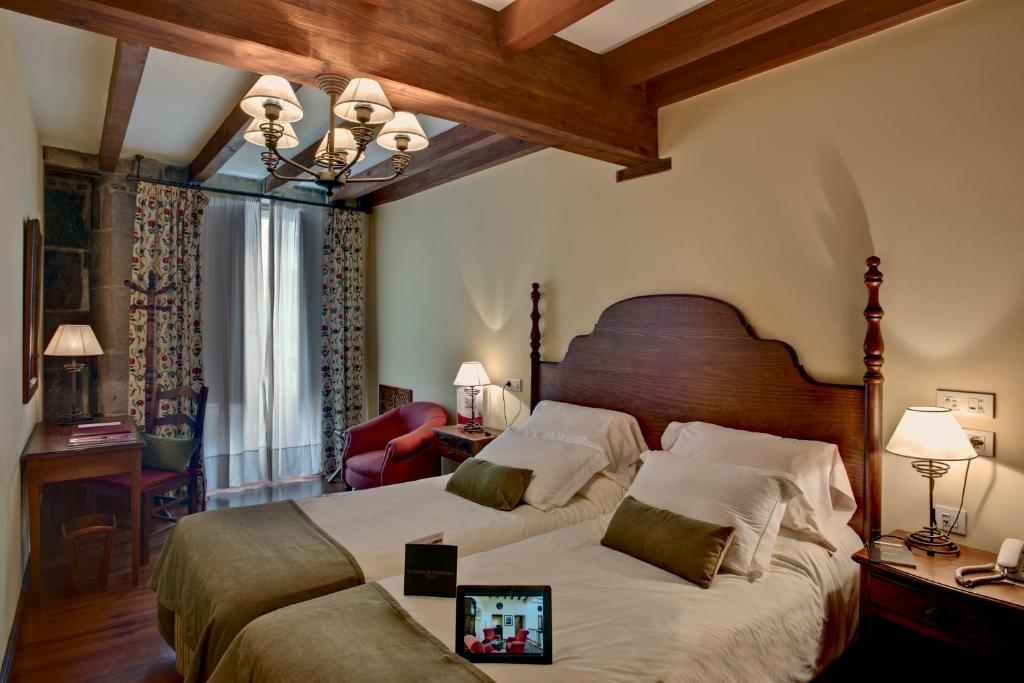 A bed or beds in a room at Airas Nunes by Pousadas de Compostela
