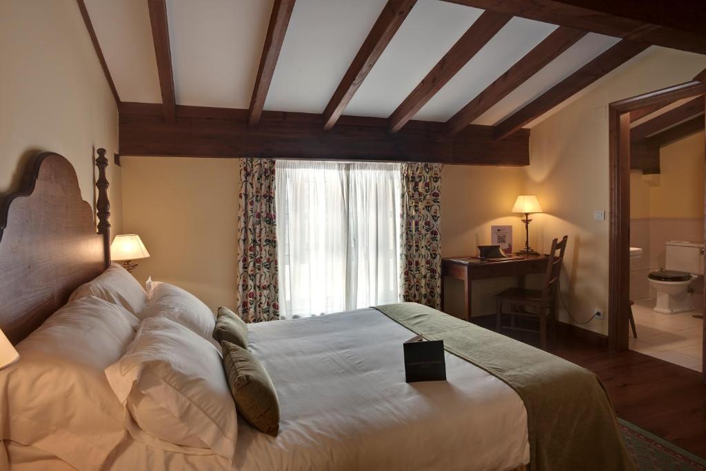 A bed or beds in a room at Airas Nunes by Pousadas de Compostela