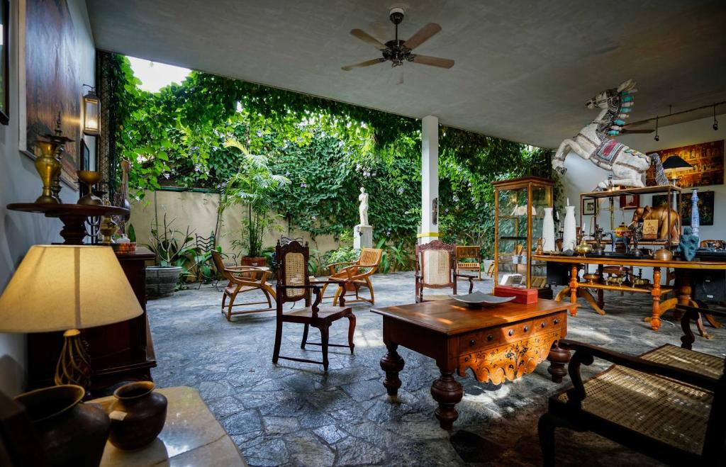 a living room with a table and chairs at Atelier in Kandy