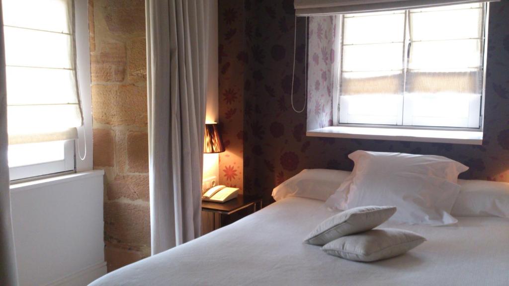 Postel nebo postele na pokoji v ubytování Hotel Palacio Muñatones