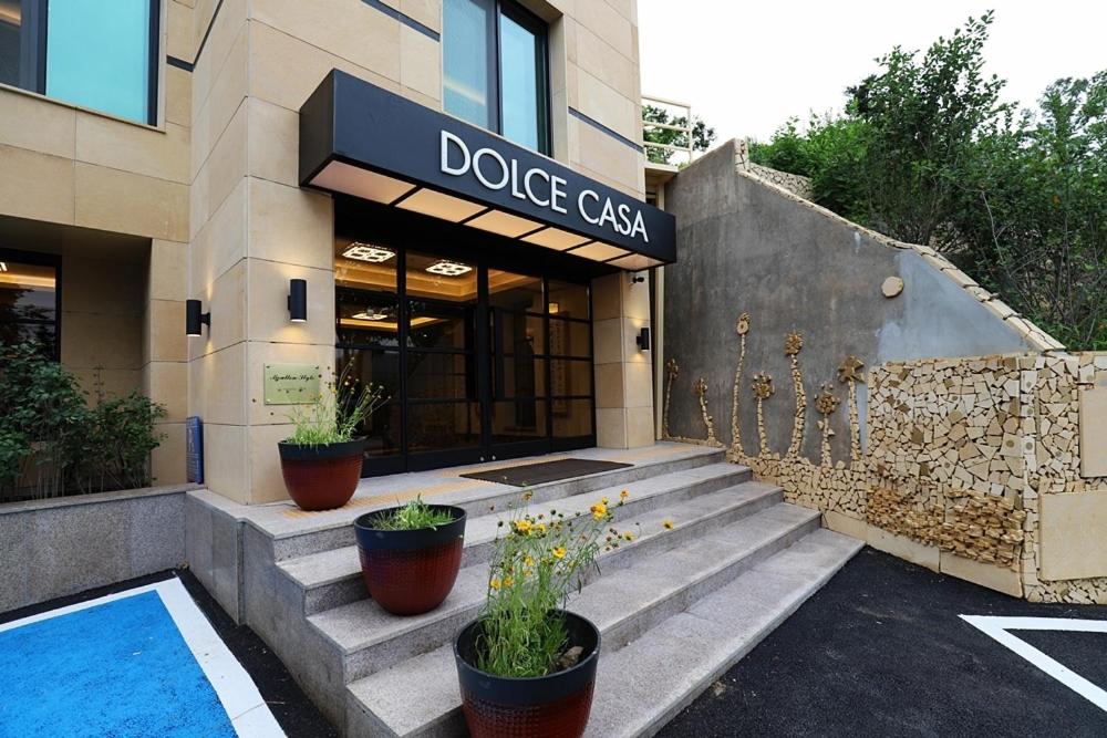 a dodge case building with potted plants in front of it at Namyangju Bukhangang dolcecasa hotel in Namyangju