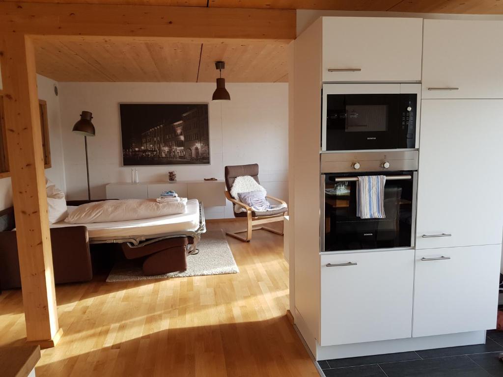 a bedroom with a bed and a tv on a wall at Ferienwohnung TREIBGUT in Uhldingen-Mühlhofen