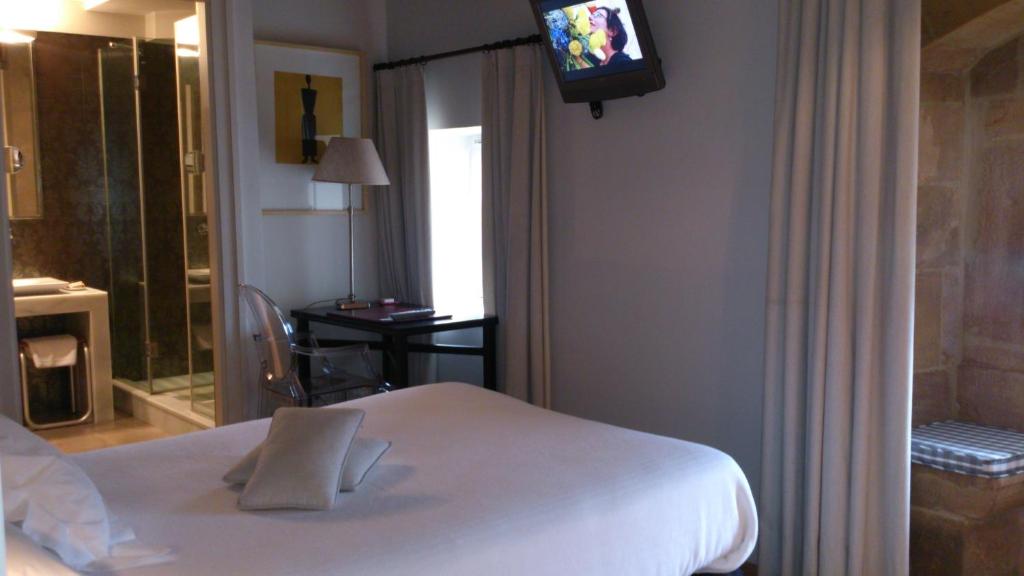 Postel nebo postele na pokoji v ubytování Hotel Palacio Muñatones
