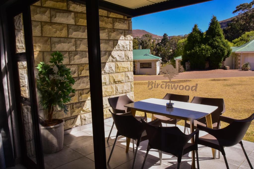 a table and chairs on the patio of a house at Birchwood A & B @ Clarens in Clarens