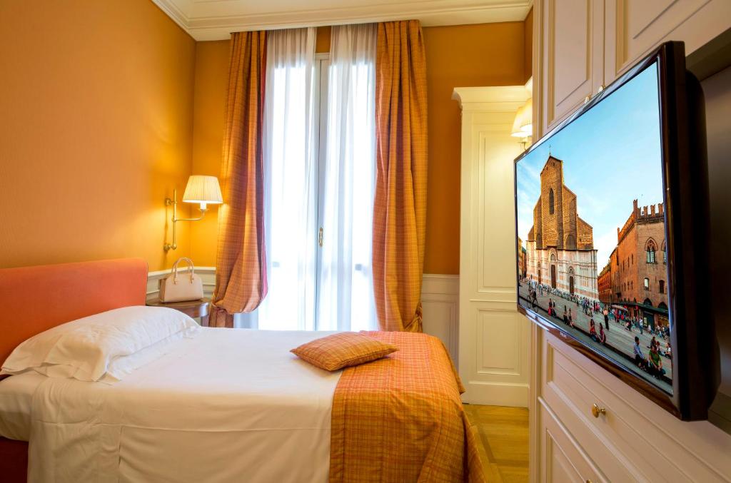 Postel nebo postele na pokoji v ubytování Hotel Corona d'Oro 1890