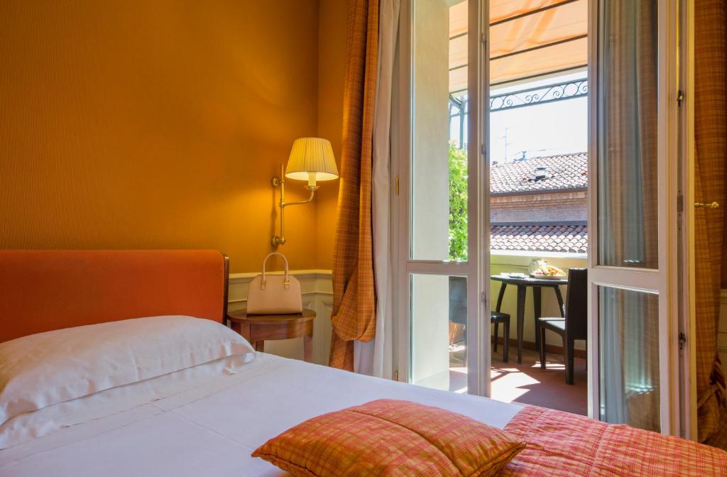 Postel nebo postele na pokoji v ubytování Hotel Corona d'Oro 1890
