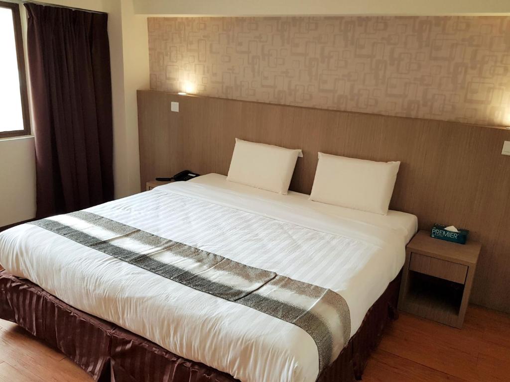 Postel nebo postele na pokoji v ubytování Check Inn Hotel Tawau