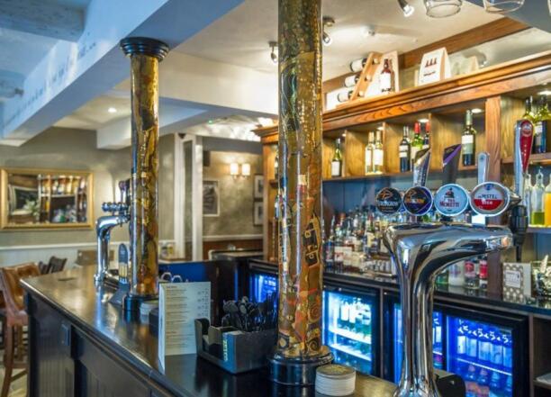 a bar with two faucets on top of a counter at The Groves Inn in Knaresborough