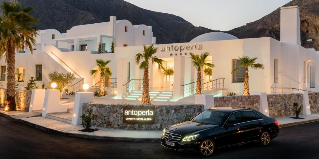 a car parked in front of a large building at Antoperla Luxury Hotel & Spa in Perissa