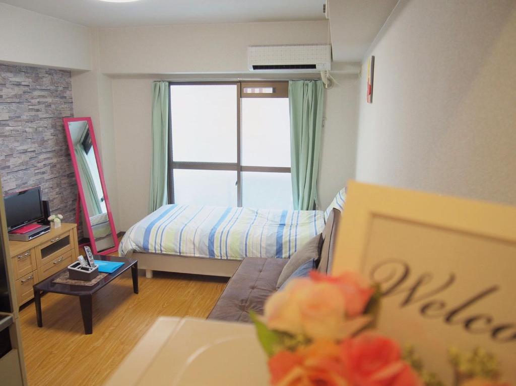 a small bedroom with a bed and a window at Free bike & free WIFI 203 Take it easy in Kyoto