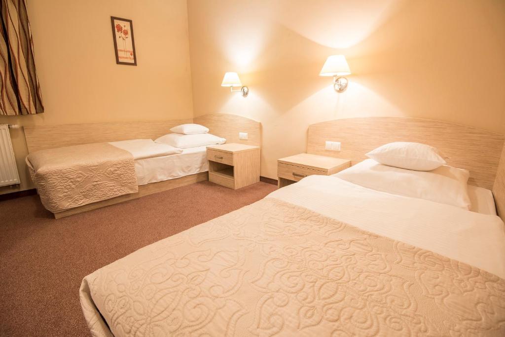 Posteľ alebo postele v izbe v ubytovaní Arena Hotel Spa & Wellness