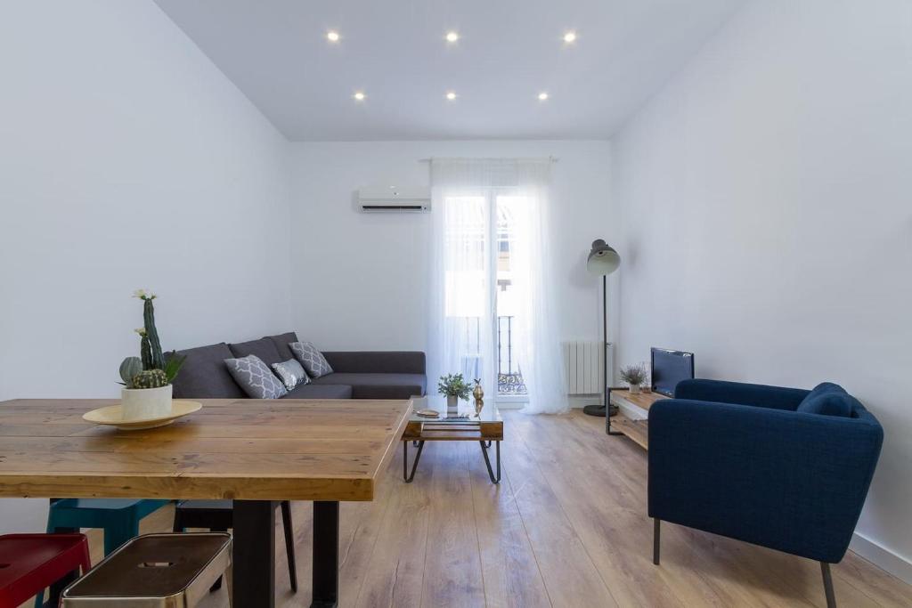 a living room with a table and a couch at Marvelous Apartment of 3 Bedrooms near La Latina by Batuecas in Madrid