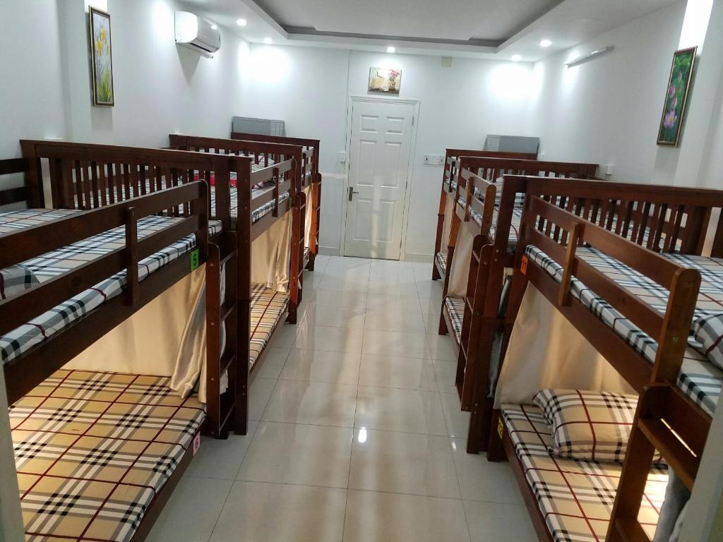 a row of bunk beds in a room at NATURAL HOUSE hostel in Ho Chi Minh City