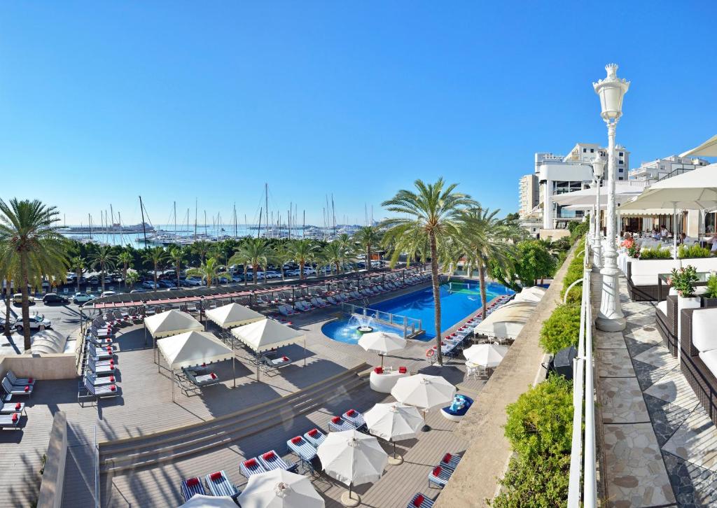 een uitzicht over een zwembad in een resort bij Hotel Victoria Gran Meliá in Palma de Mallorca