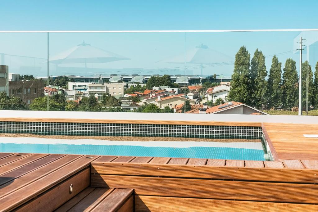 a swimming pool on the roof of a house at Oporto Airport & Business Hotel in Maia