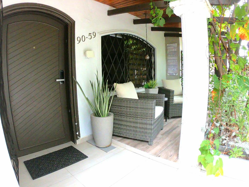 an open door to a patio with a couch and a table at Vestigium Bed and Breakfast in Barranquilla