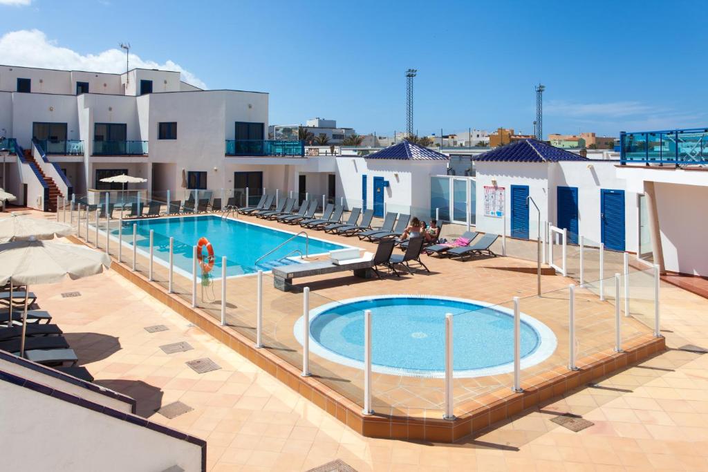 a swimming pool on the roof of a building at TAO El Cotillo in El Cotillo