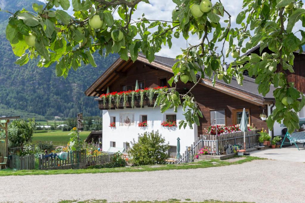 a house with flowers in front of it at Lahnerhof in Campo Tures