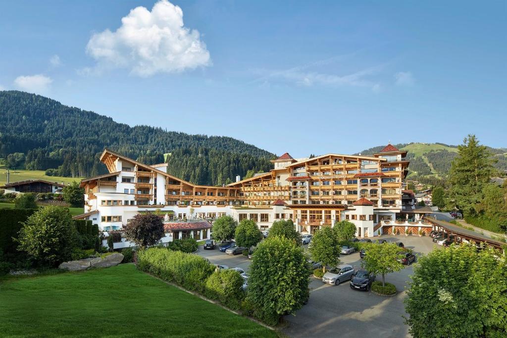 
a large building with a lot of trees at Sporthotel Ellmau in Tirol in Ellmau
