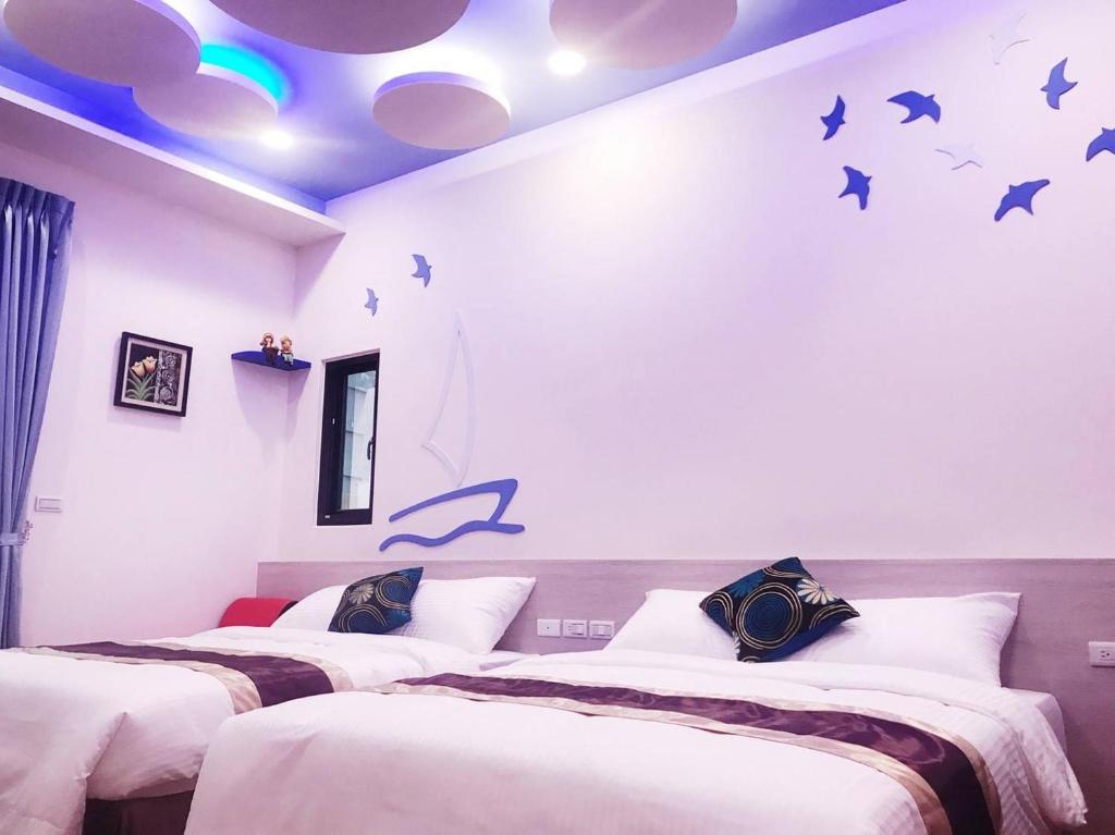 Postel nebo postele na pokoji v ubytování Purple Shell Homestay II
