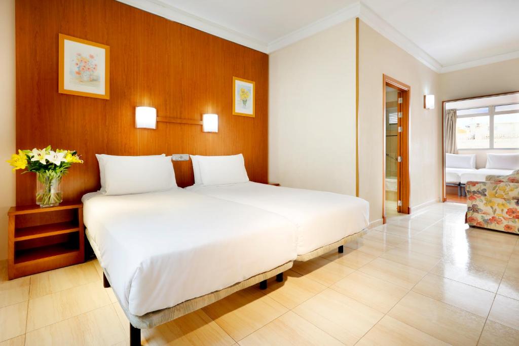 a bedroom with a large white bed in a room at Crisol Alisios Canteras in Las Palmas de Gran Canaria