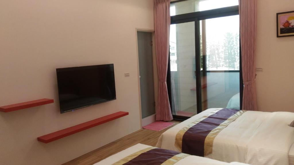 Postel nebo postele na pokoji v ubytování Purple Shell Homestay II
