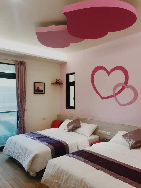 Postel nebo postele na pokoji v ubytování Purple Shell Homestay II