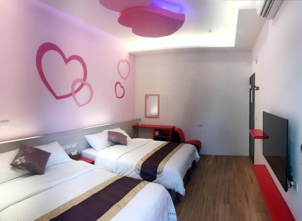 Postel nebo postele na pokoji v ubytování Purple Shell Homestay II