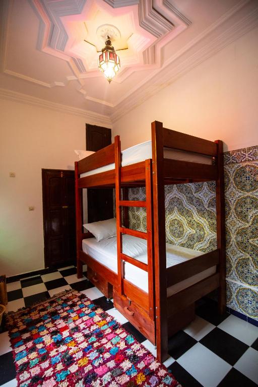 Postel nebo postele na pokoji v ubytování Mosaic Hostel