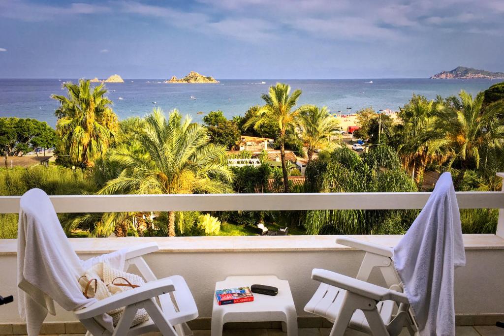 a balcony with chairs and a view of the ocean at Hotel Mediterraneo in Santa Maria Navarrese