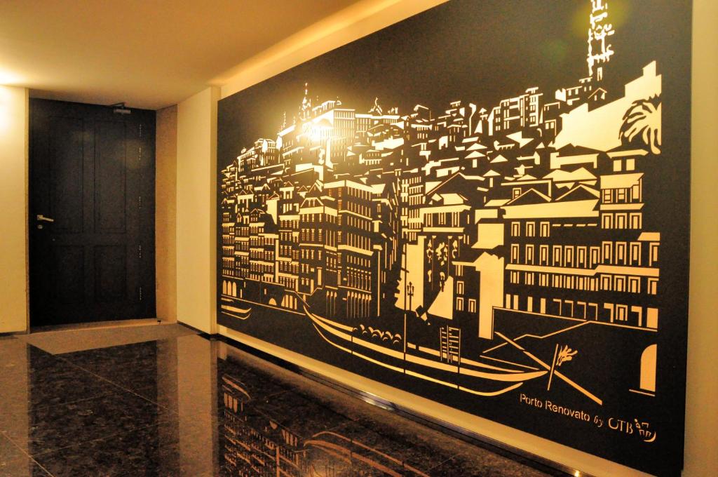 a painting of a city on a wall in a room at PicPorto Apartment in Porto