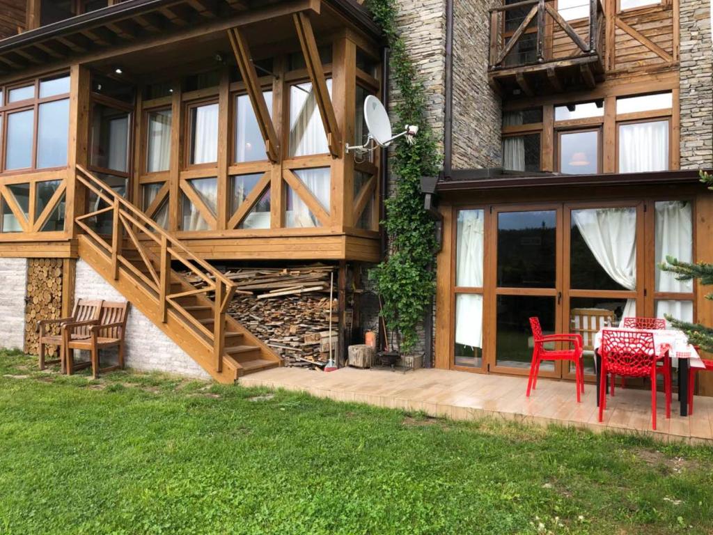 a house with a patio with a table and chairs at Katarino Villa Nature Escape in Razlog