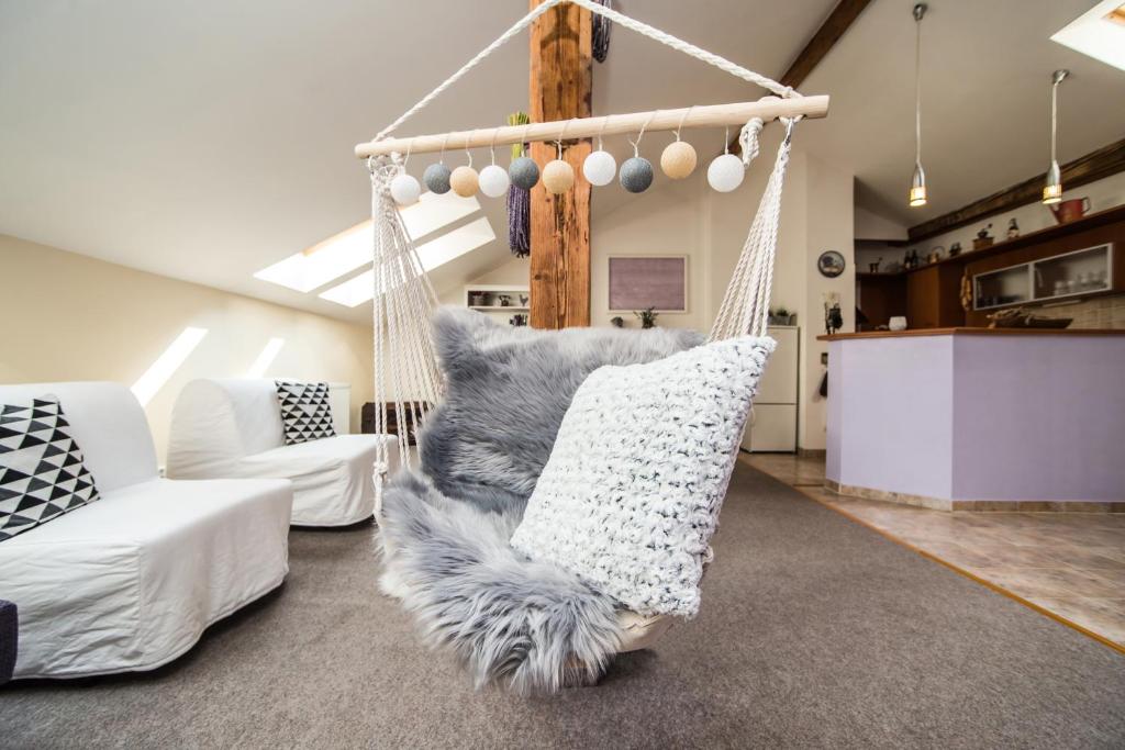 a swing with a furry pillow in a living room at LaNoblessa in Prague