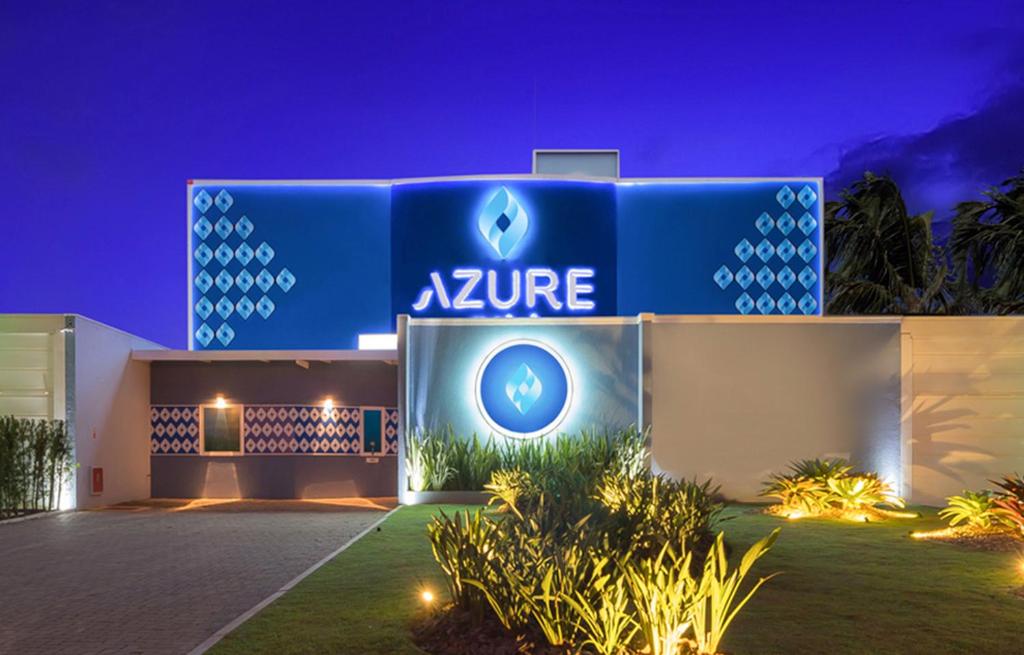 a blue building with a zine sign on it at night at Azure Motel (adults only) in Registro
