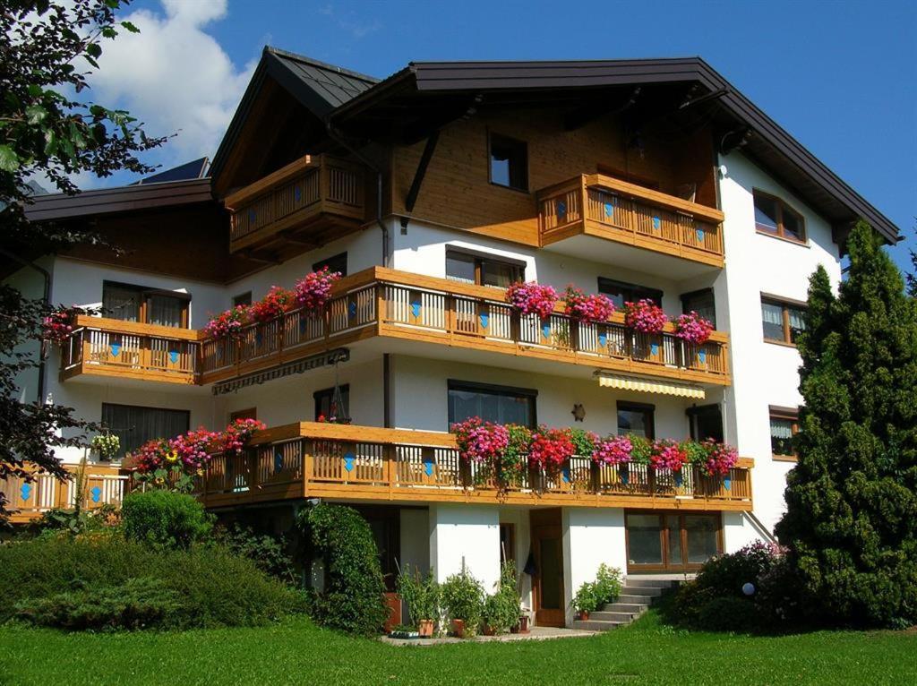 a building with flower boxes on the balconies at Ferienwohnung Dreer in Hofen