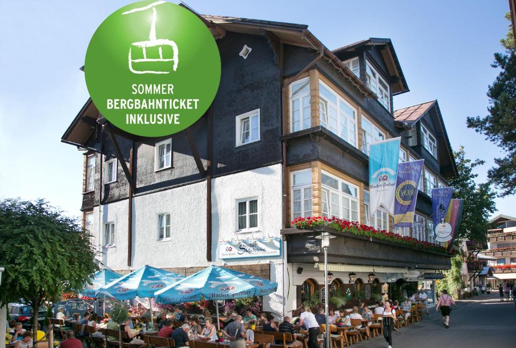 a group of people sitting outside of a building at Sascha's Kachelofen in Oberstdorf