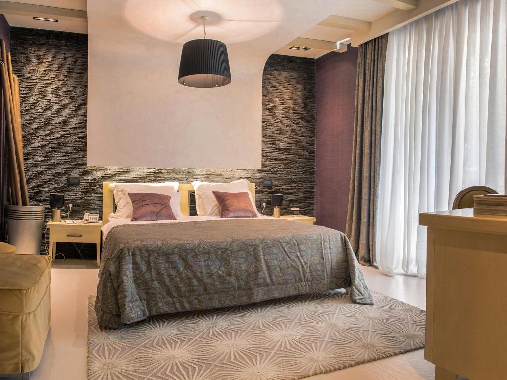 Postel nebo postele na pokoji v ubytování Hotel Forza Mare