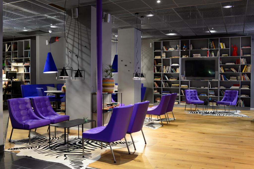 a room filled with lots of chairs and tables at Connect Hotel City in Stockholm
