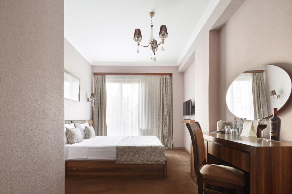 Postel nebo postele na pokoji v ubytování Hotel Pushkin