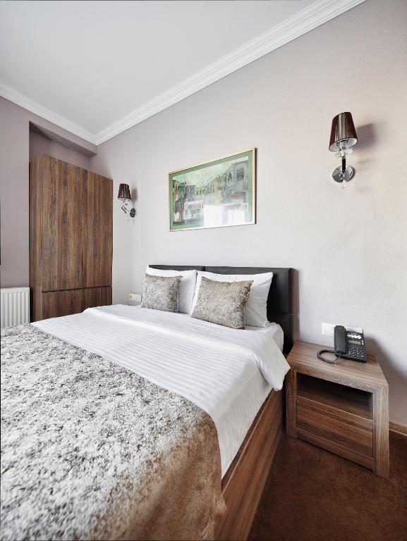 Postel nebo postele na pokoji v ubytování Hotel Pushkin