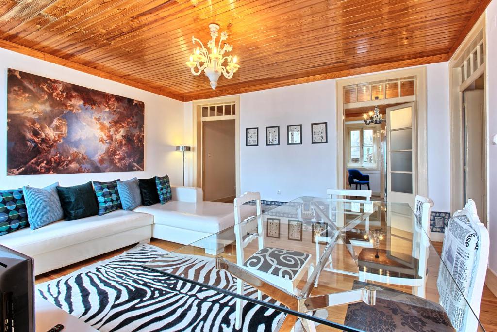 een woonkamer met een bank en een glazen tafel bij Portas do Teatro Apartments in Lissabon