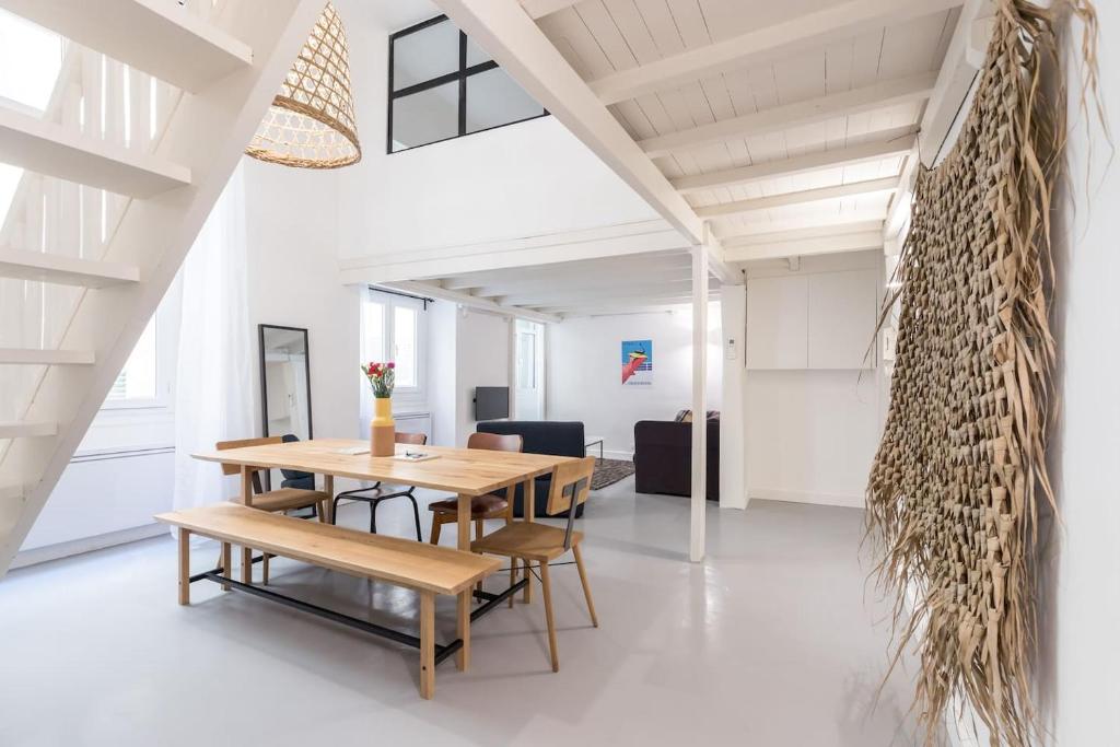 une salle à manger avec une table et des bancs en bois dans l'établissement Prefecture Duplex - Old Town, à Nice