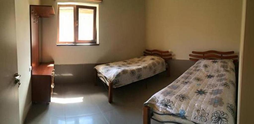 Postel nebo postele na pokoji v ubytování Guest House Lasili