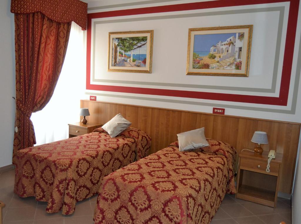 Postel nebo postele na pokoji v ubytování Hotel Facioni