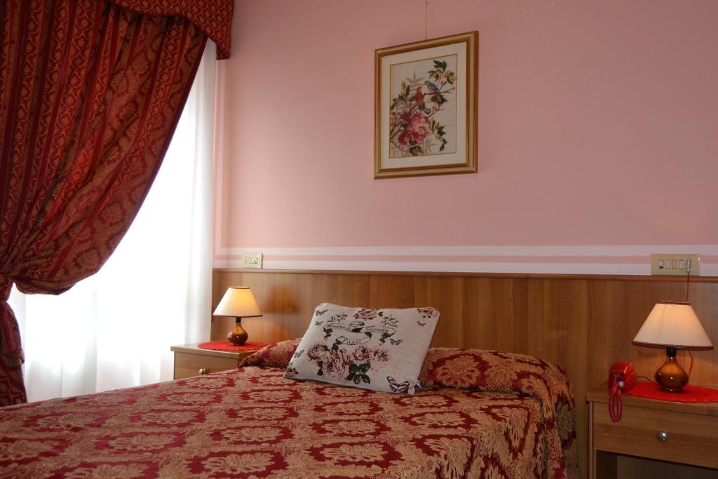 Postel nebo postele na pokoji v ubytování Hotel Facioni